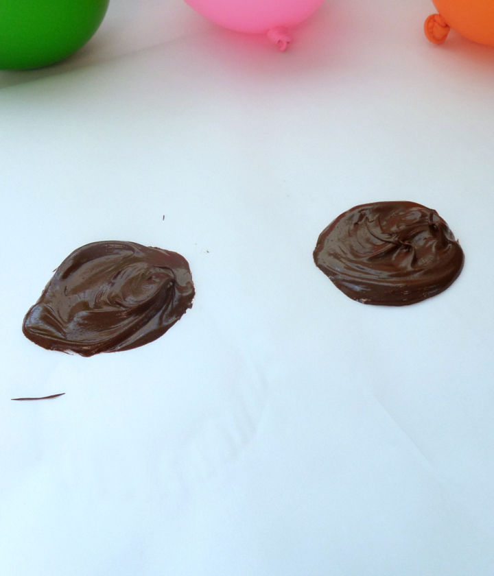 Spoon chocolate onto wax paper to form bases for chocolate dessert bowls