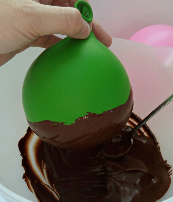 dip the balloons into melted chocolate 