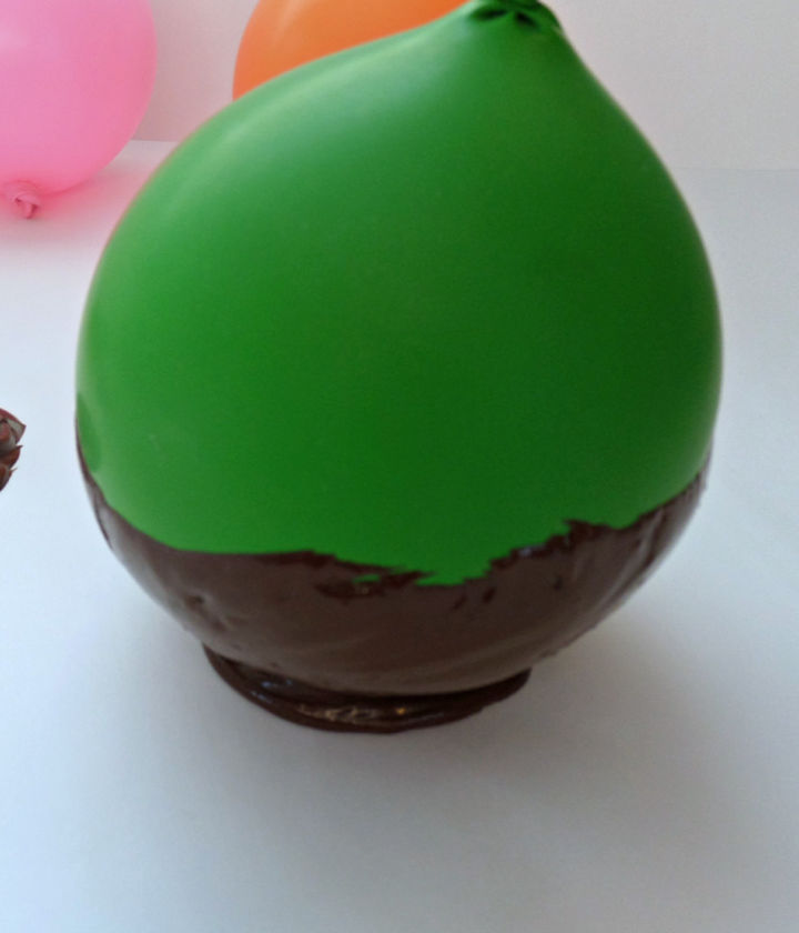 place the chocolate covered balloon onto chocolate base